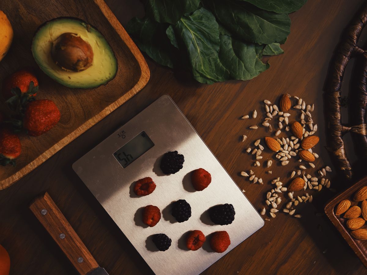 Kitchen scale weighing berries and produce, useful for portioning recipes when meal prepping for one