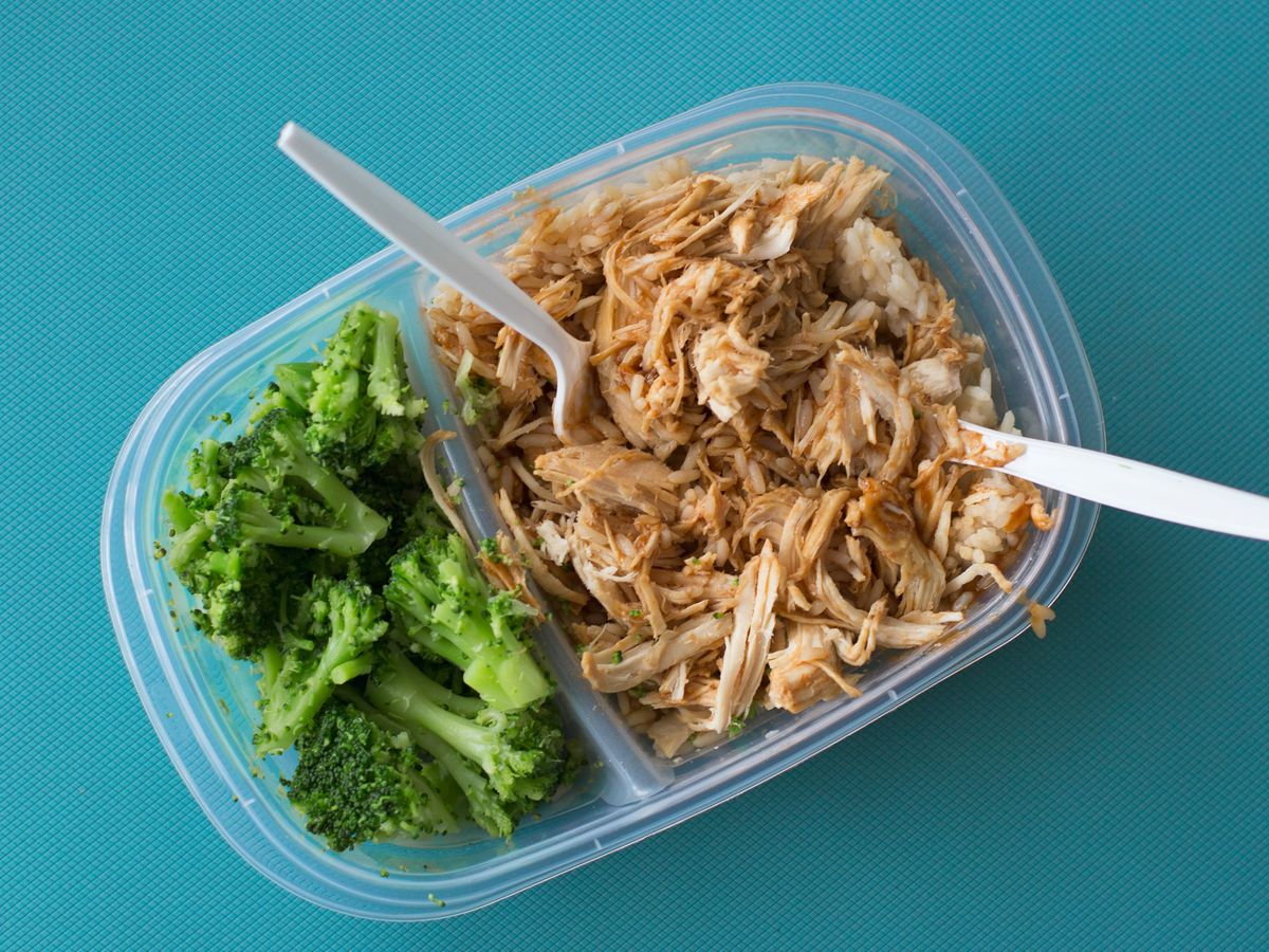 Single-serving container of shredded chicken, rice, and broccoli for a first-week meal prep plan